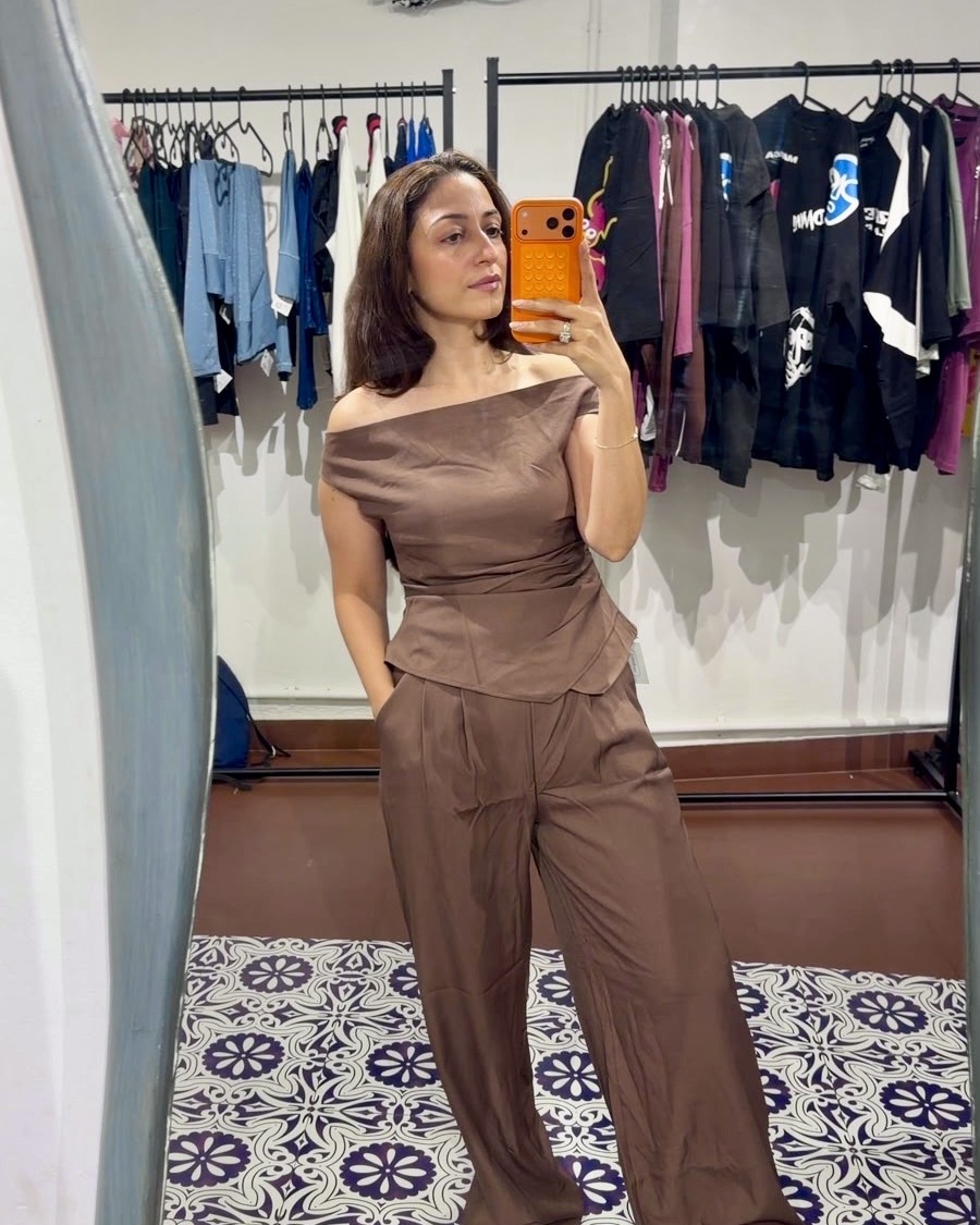 Inside Unfound — trying on a brown coord set in the mirror