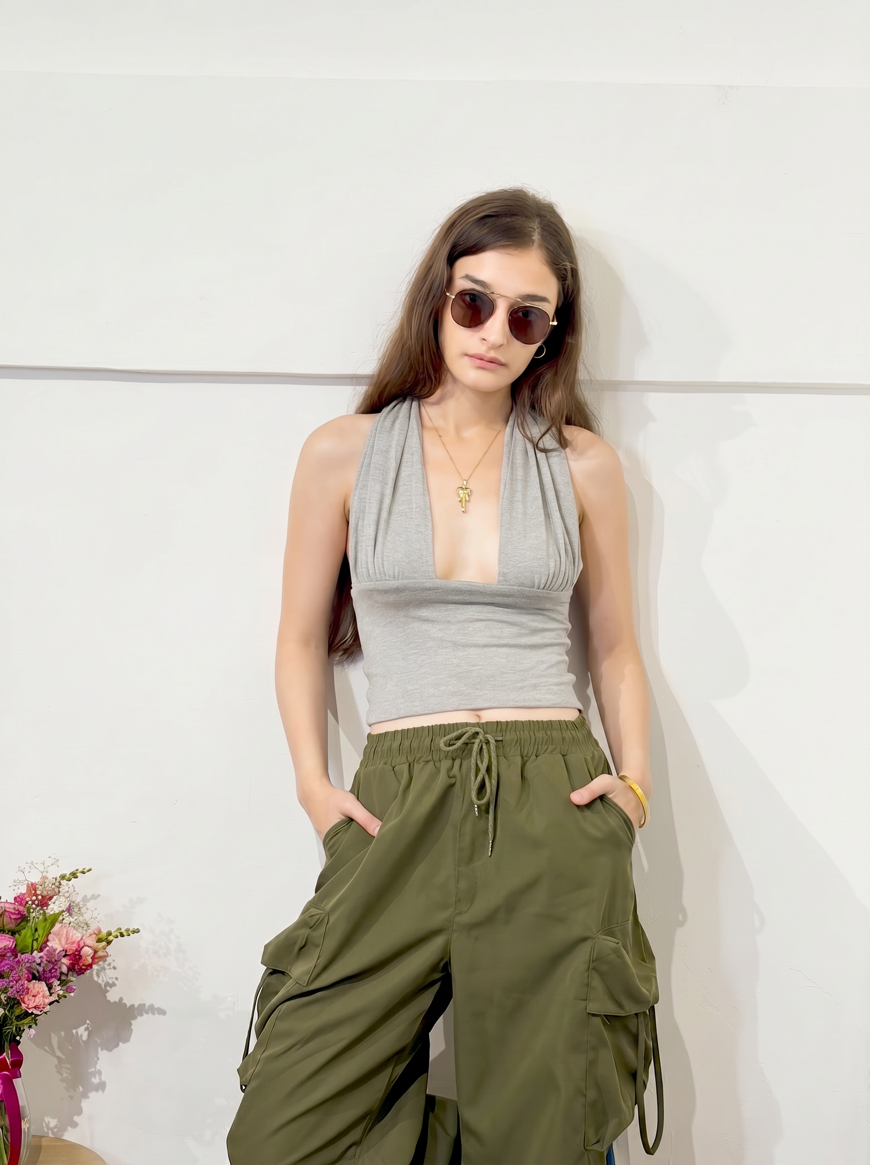 Customer in a grey halter top and olive cargo pants at Unfound
